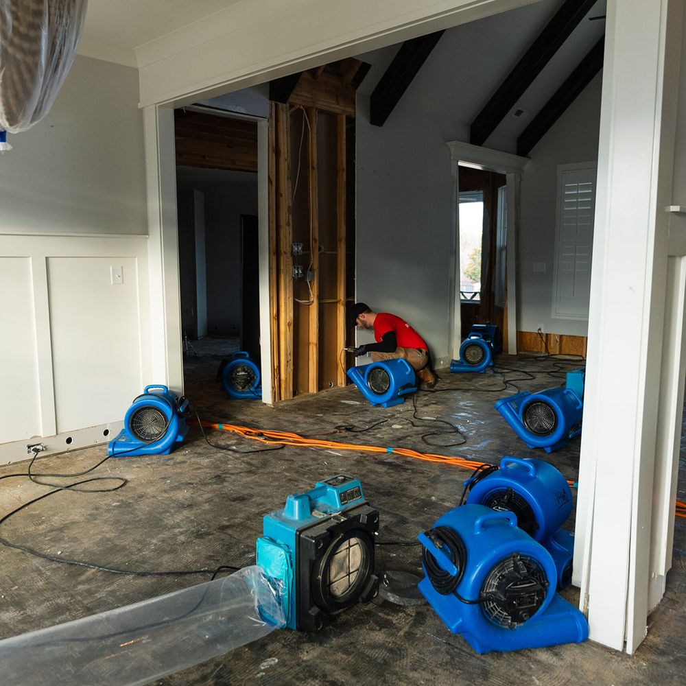 drying a clients floor with water damage restoration equipment in nashville