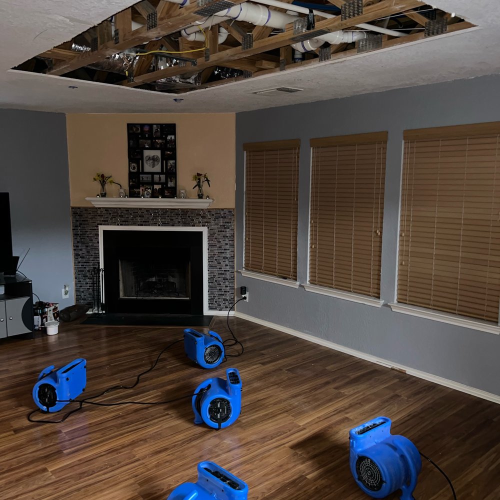 Technicians drying hardwood floors during professional water damage restoration in Nashville